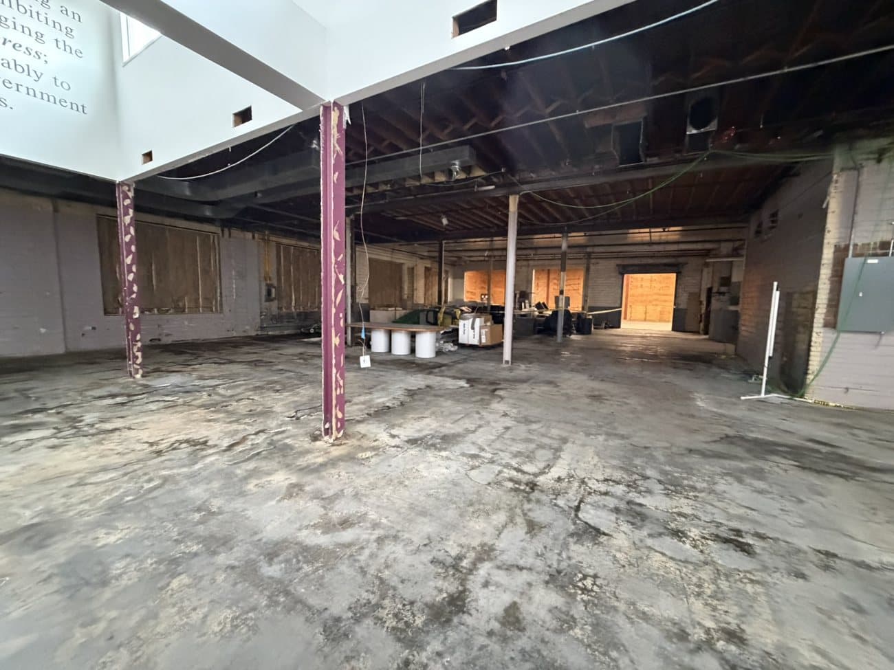 A wide open ground-floor space with original columns