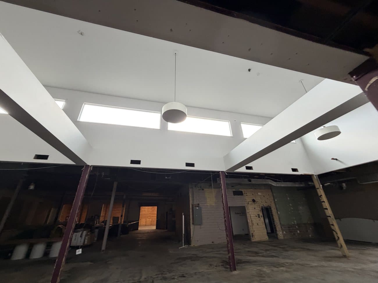 A bright, open upper floor with exposed wood-beam ceilings